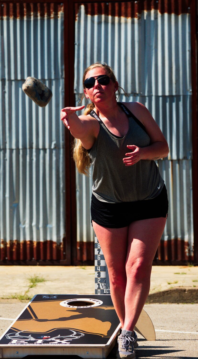 Heather Mullins competes in the late afternoon heat Saturday on the way to winning a championship with cornhole partner Aaron Graham. [bag a corn hole print]